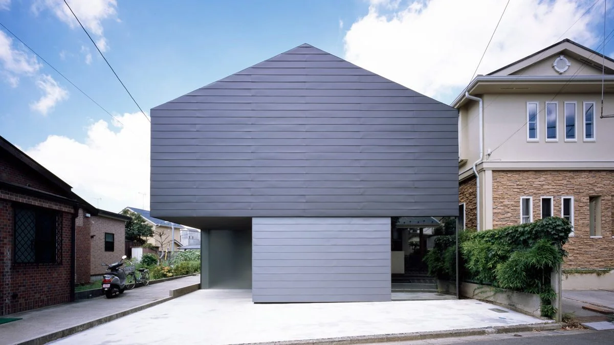 Leaf House has blank metal facade to hide tree-planted courtyard